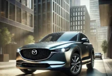 2025 Mazda CX-5 parked in an urban setting, showcasing its sleek design, elegant front grille, and glossy exterior.